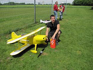 Ein Pilot tankt seinen gelben Doppeldecker auf